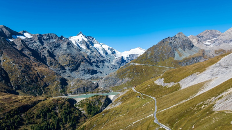 Die beeindruckende Bergkette des Großglockners mit schneebedeckten Gipfeln und klar blauem Himmel im Hintergrund.